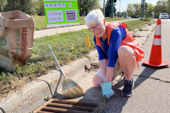 A Green Team member cleans a storm drain
